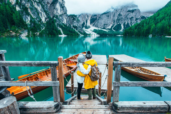 Mountain stories. Happy couple on a wanderlust vacation. Boyfriend and girlfriend spending time together at the lake. Storytelling concept about lifestyle and winter travels