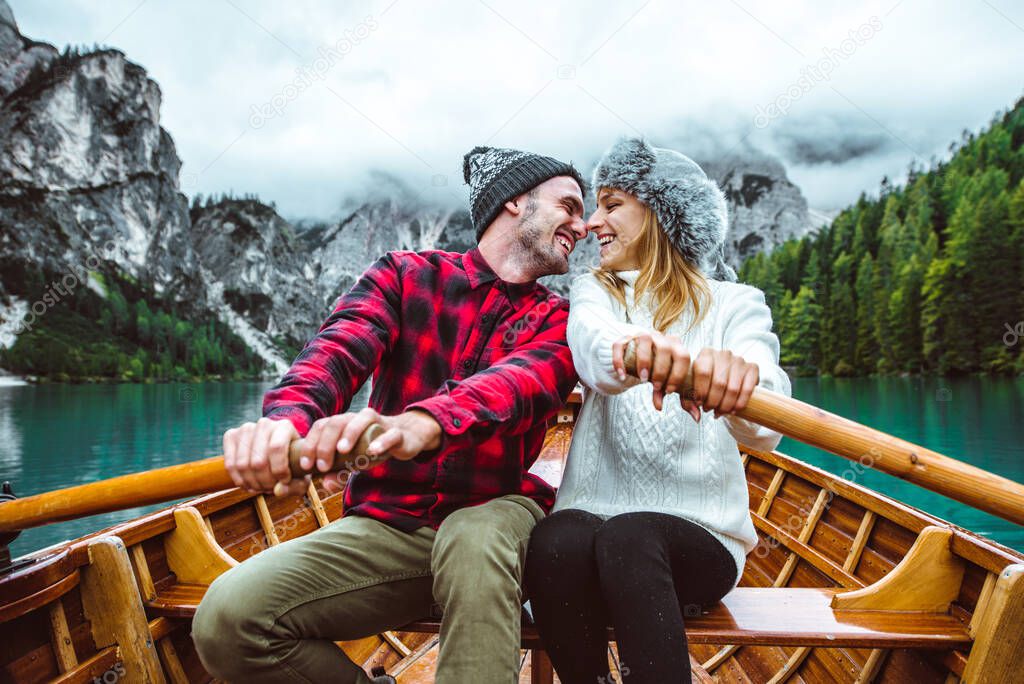 Mountain stories. Happy couple on a wanderlust vacation. Boyfriend and girlfriend spending time together at the lake. Storytelling concept about lifestyle and winter travels