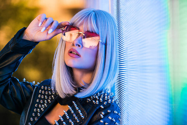 Pretty girl with stylish clothes posing near led lights - Beautiful woman portrait