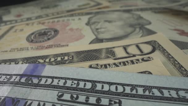 Beaucoup de billets de dollars américains sur la table. Macro shot avec filigranes, inscription, président américain, billet — Video