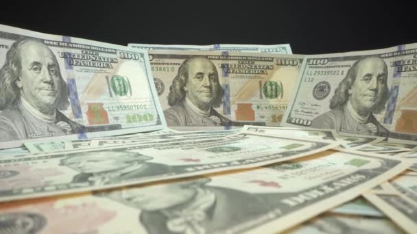 USD american bills on the table with black background. Low angle. Macro shot. Camera move forward to hundred dollars bill. Strong currency. Macro money. Bank note. USA president Benjamin Franklin — Stock Video