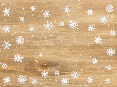 Kahverengi ahşap Noel arkaplanı ve kar taneleri. Noel ve