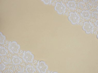 White lace on a beige background clipart