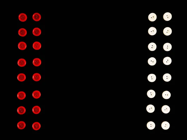 Botões de plástico vermelho e branco em linha no fundo preto — Fotografia de Stock