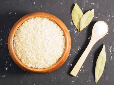 Siyah beton arka planda pirinç ve baharatlar. Hint mutfağı.