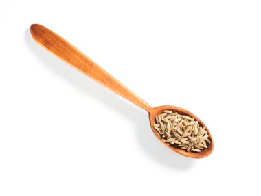 Kimyon tohumları (Cuminum), Jeera tahta kaşıkla beyaz bir sırt deliğinde