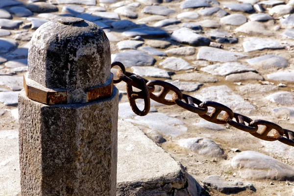 stone pillar with chain close up shot