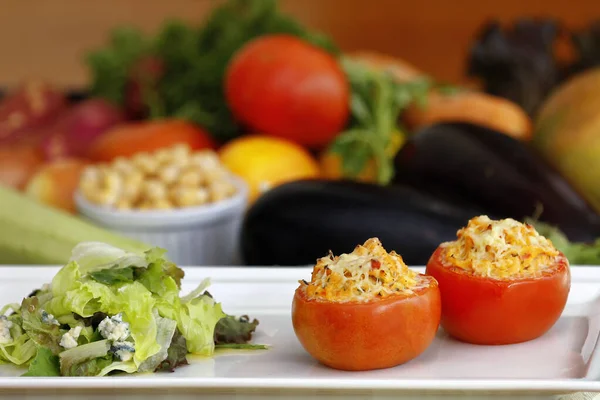 Vegan food: roasted tomatoes with chicken puree accompanied by lettuce salad.