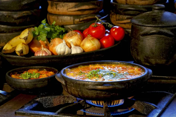 Lezzetli Moqueca capixaba ve kil kaplarda sebzeler