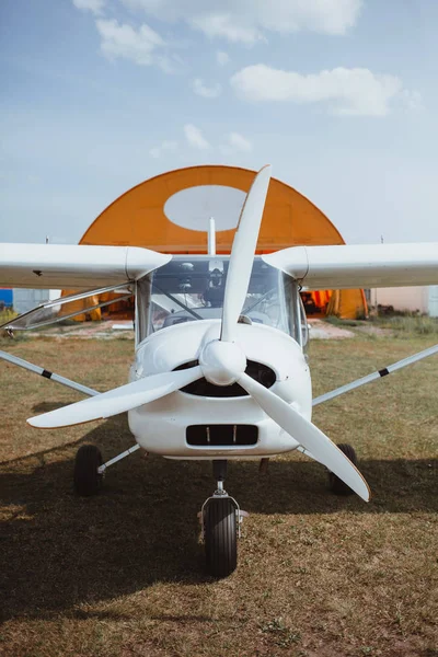 a small white plane stands on the ground