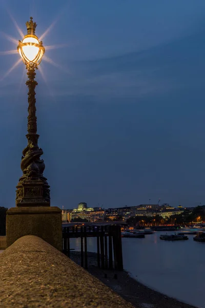 Street light on the side of the Thames in London