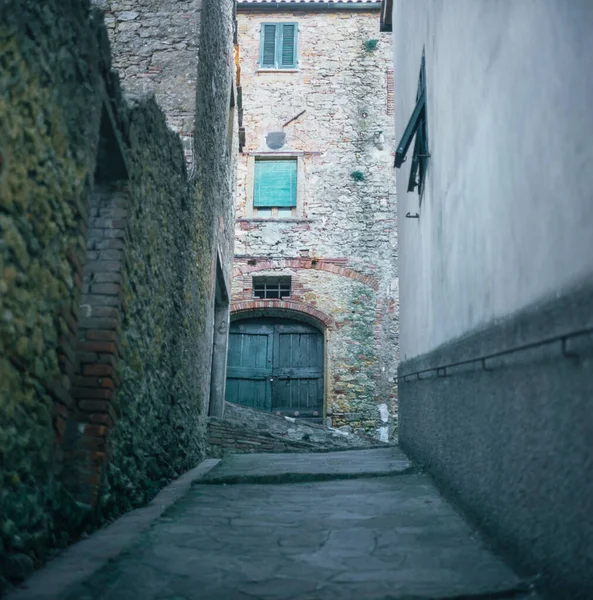 Colorful narrow street in the medieval town of Campiglia Marittima in Tuscany with slide film photography
