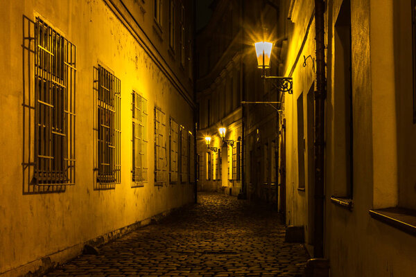 Old cobbled streets and buildings of Prague Old Town at night in Autumn