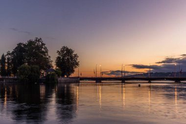 Cenevre 'deki köprü gün doğumunda göle yansıyor.