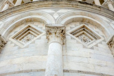 Details of the outside of the leaning tower of Pisa in Autumn day