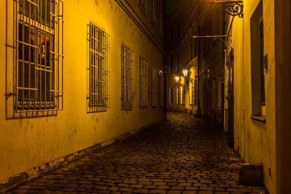 Old cobbled streets and buildings of Prague Old Town at night in Autumn