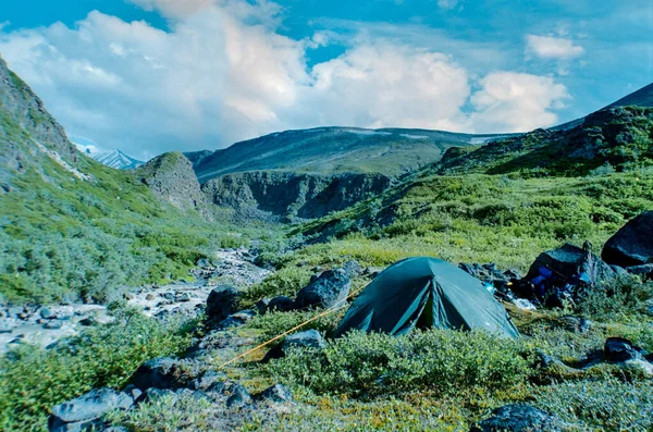 Tent pitched near small river in the Wrangell-St. Elias National Park and Preserve