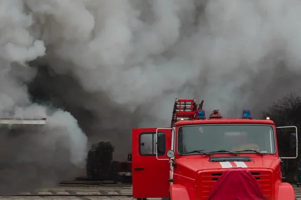 fire fighting and assistance. fire engine in the smoke from the fire