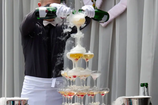 Catering service. Wedding slide champagne for bride and groom outdoors. Catering bar for celebration