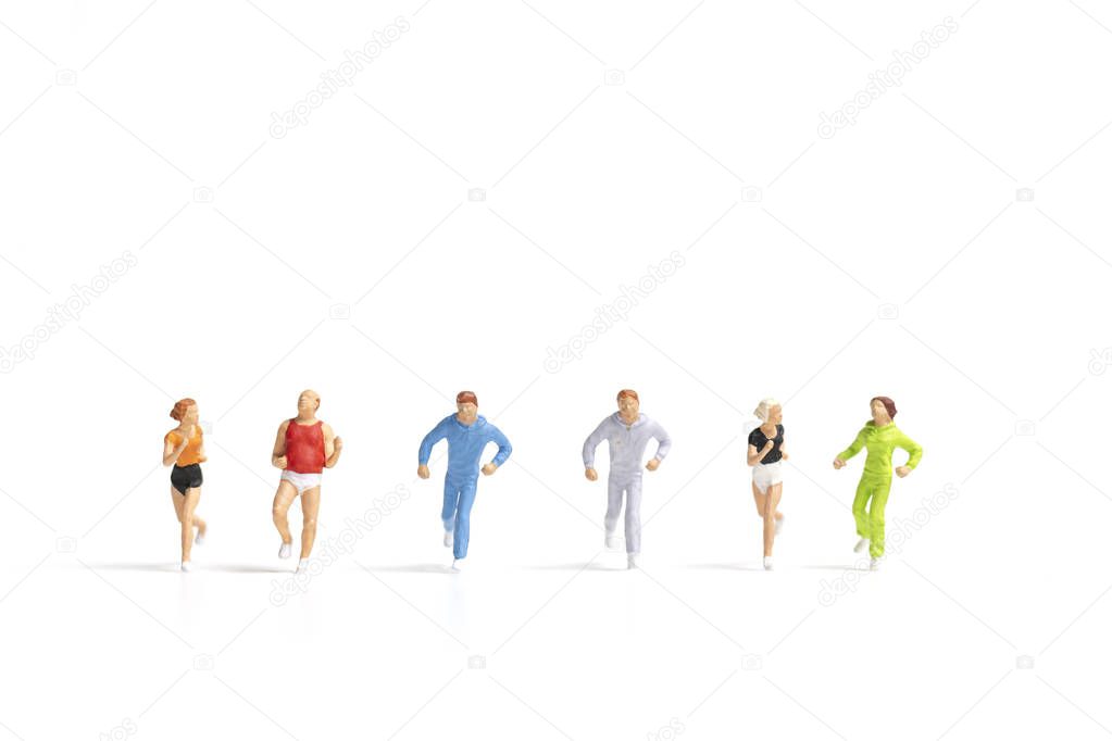 Miniature people running on white background , Healthy lifestyle and sport concepts.