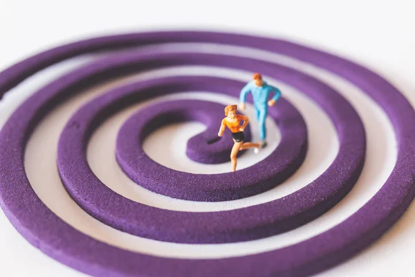 Miniature people : Couple Runnig on the purple field , Valentine\'s Day concept