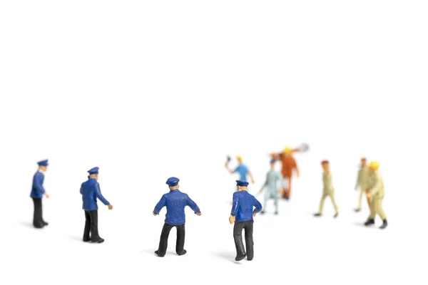 Miniature people : Police and an angry mob on white background