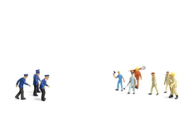 Miniature people : Police and an angry mob on white background