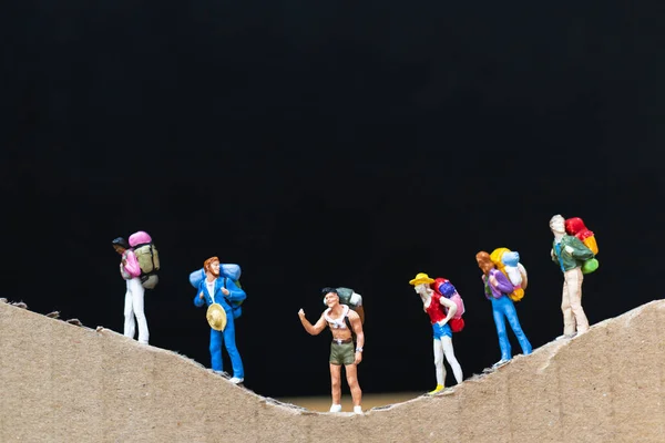 Miniature people :  Traveler with backpack walking on The paper mountain — Stock Photo, Image