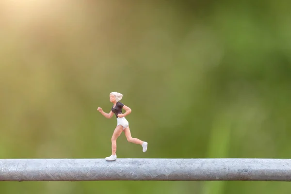Miniature people : Young people running on a wire