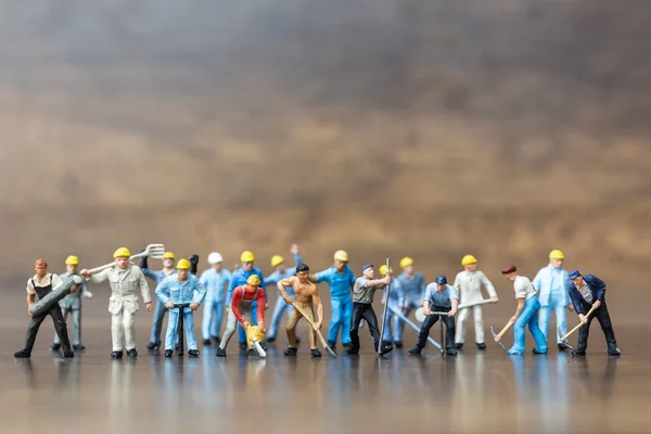 Miniature people : Group of  Worker team holding tool — Stock Photo, Image