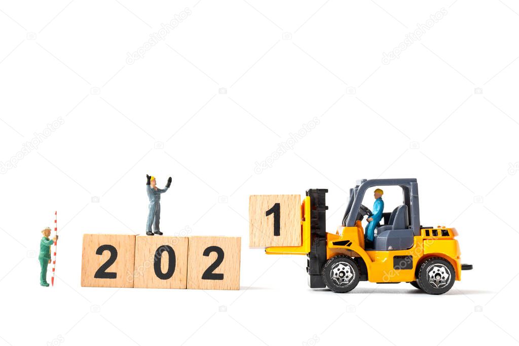 Miniature Worker team create wooden block number 2021 , Happy new year concept