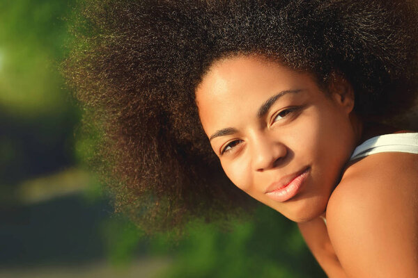 Young pretty afro woman close up portrait on natural