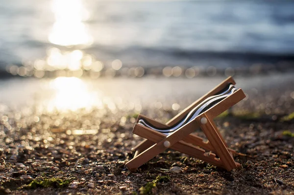 Καρέκλες παραλίας στην αμμώδη παραλία το ηλιοβασίλεμα. καλοκαιρινό φόντο — Φωτογραφία Αρχείου