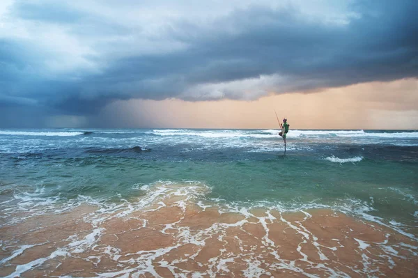 silhouette of fisherman on sunset with beautiful dramatic sky