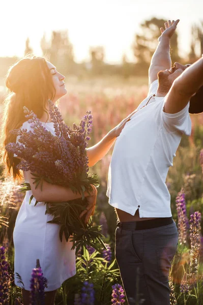 Jovem Casal Com Buquê Lupine Romancing Campo — Fotografia de Stock