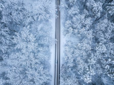 Mounta'da kış yolunun havadan görünümü ve ormanın yanından geçen arabalar