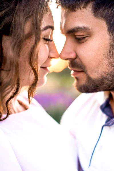 Portrait of romantic couple face to face in sunset nature