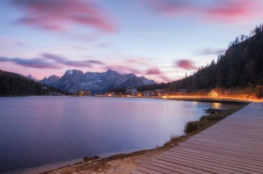 famous tourist place Lake Lago di Misurina on sunset. picture with long exposure and amazing dramatic sky    clipart