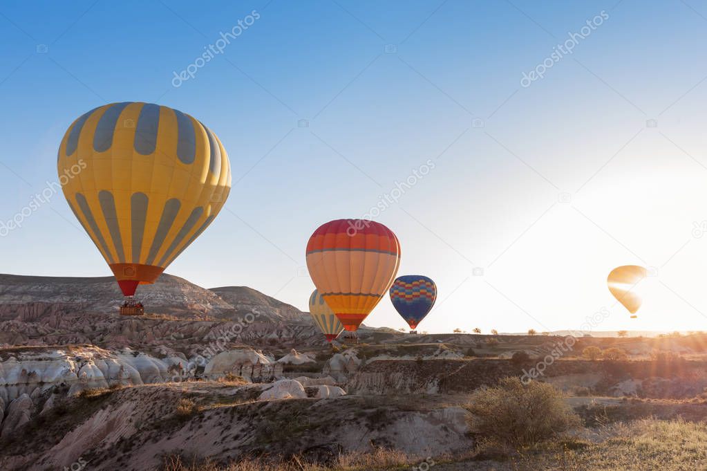 view of colorful hot air balloons flying over the Red valley on 