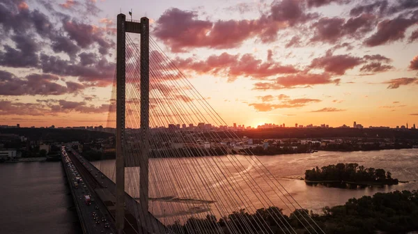 Hava gece şehir manzarası, aydınlık binalar ve köprü. İHA atışı.