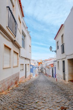 Lagos, Portekiz - 04 Mayıs 2017: Beyaz ve renkli (kırmızı, mavi, sarı ve yeşil) çiçekle süslenmiş eski Avrupa şehir caddesi.