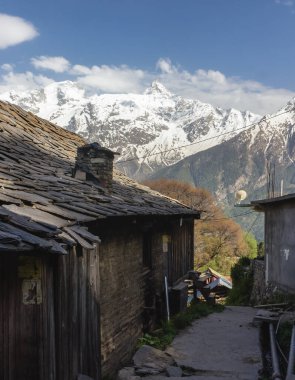 Hindistan 'ın Kalpa köyündeki Kinner Kailash sıradağlarının tepelerine karşı geleneksel Kinnauri evinin tahta çatı manzarası.