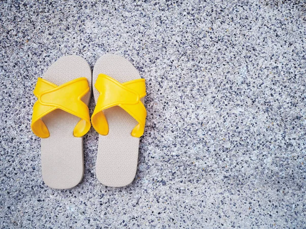 Gele sandaal aan rand van het zwembad. — Stockfoto