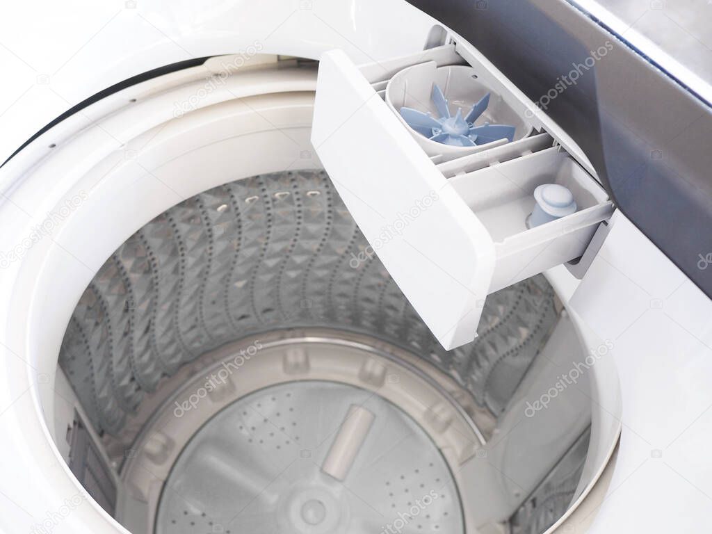 Top view of white washing machine without clothes loaded inside.