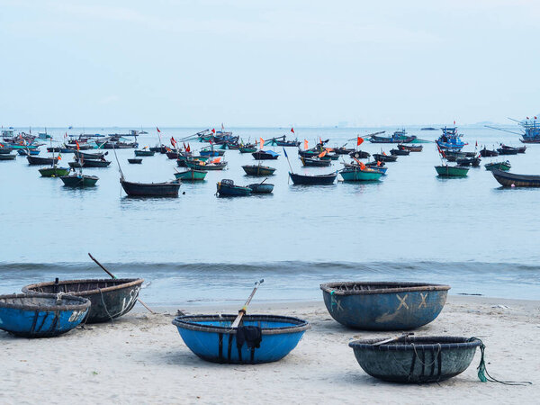 The traditional round basket boat is made of woven bamboo on My Khe Beach, Danang, Vietnam. 