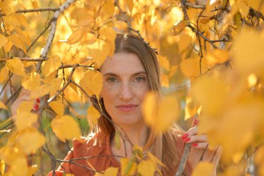 Sarı yapraklı güzel bir genç kadının enfes portresi.