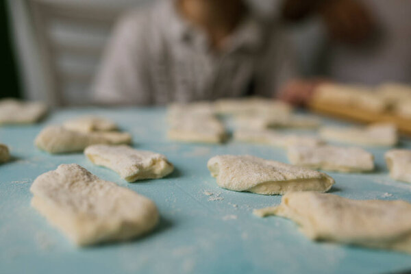 pieces of dough in flour on the table