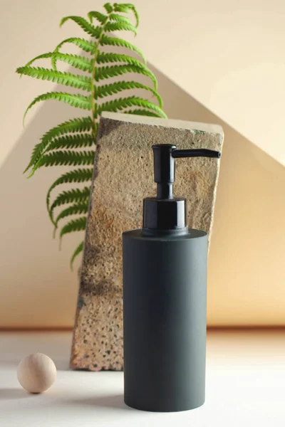 Gray cosmetic dispenser with space for your logo. Spa concept, skin care.