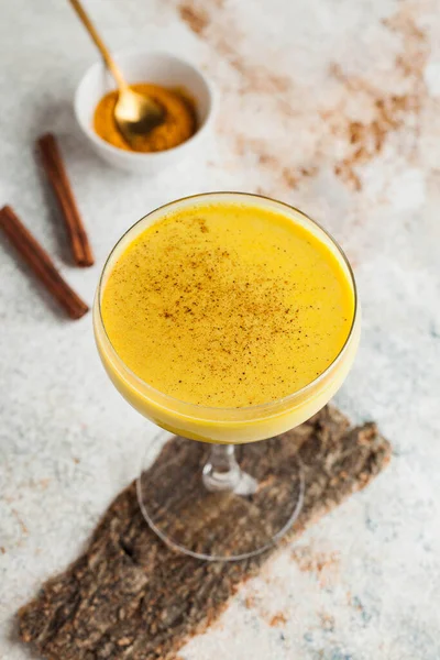 Moon milk for better sleep. Turmeric Golden milk with cinnamon. A trendy relaxing drink before going to bed. Ayurvedic drink. High quality photo