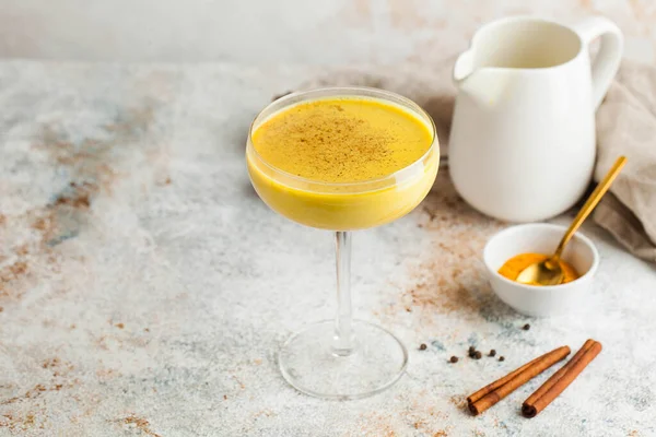 Moon milk for better sleep. Turmeric Golden milk with cinnamon. A trendy relaxing drink before going to bed. Ayurvedic drink. High quality photo